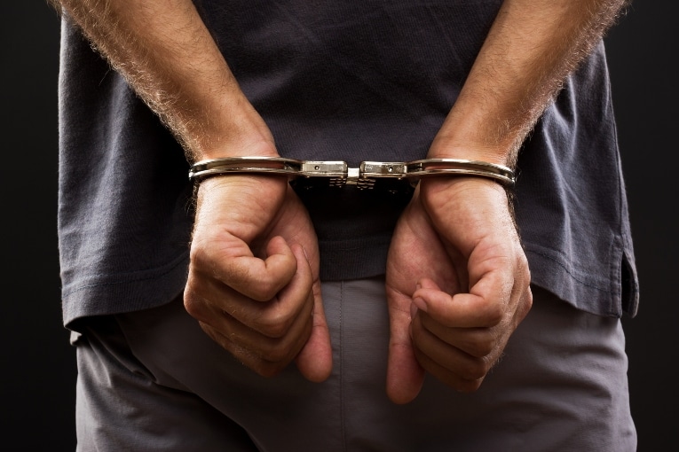 Person in handcuffs for a criminal defense trial